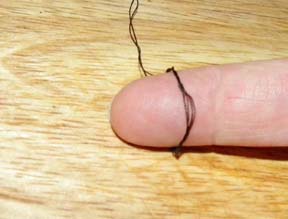 Roll the thread down your finger